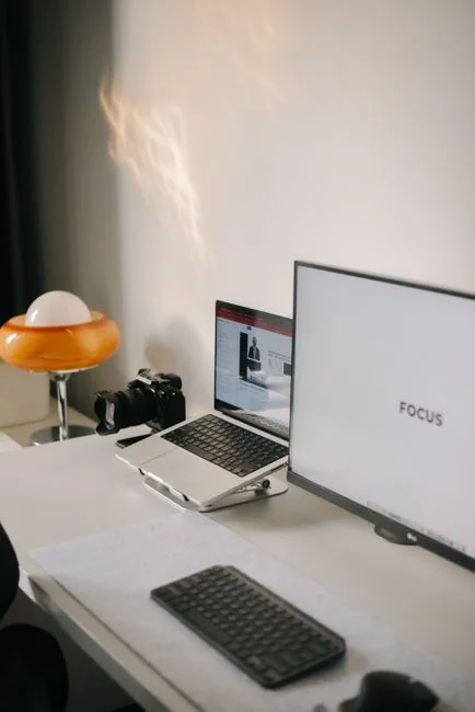 Close-up of hands using a laptop indoors to browse a shopping website on the screen.